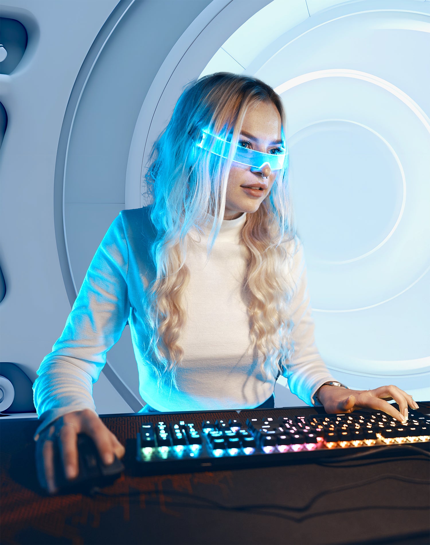 a cyber girl using an Illuminated high-tech keyboard and computer monitor in spaceship