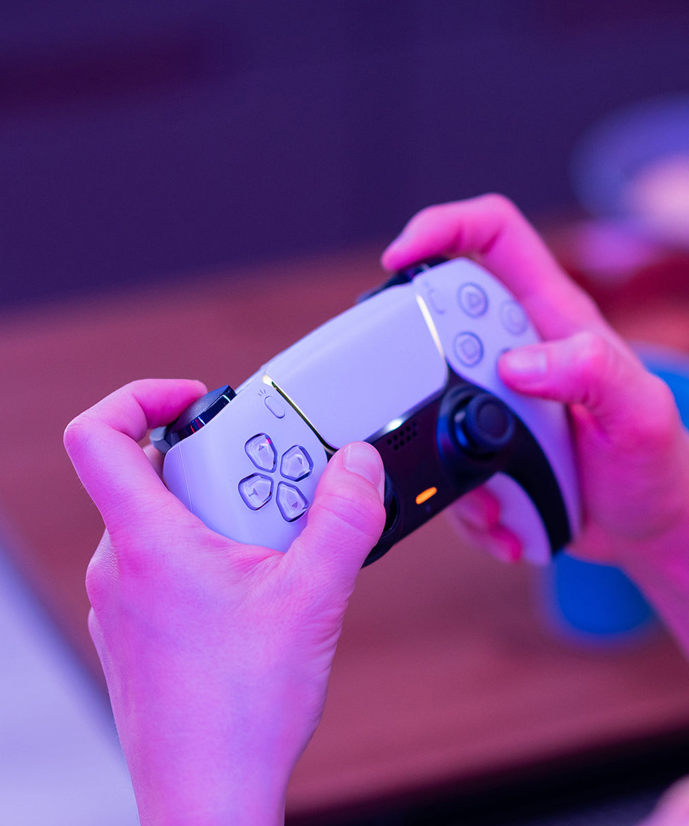a person holding a game controller to play games